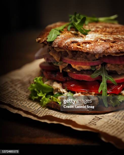 layered sandwich with toasted bread, bacon, cheese and tomato sauce on dark background - toasted sandwich stockfoto's en -beelden