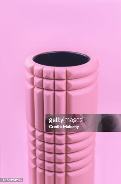 pink foam roller on pink background. - exercise equipment stock pictures, royalty-free photos & images