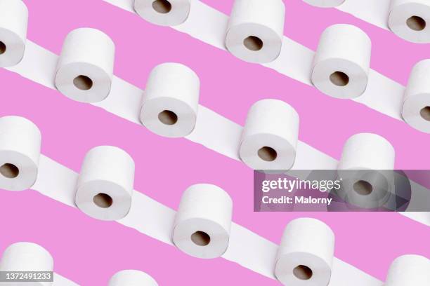 toilet paper on pink background. - wrapped in toilet paper ストックフォトと画像
