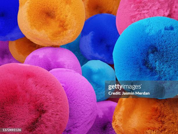 fluffy soft fur balls background - pom pom stock-fotos und bilder