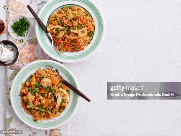pilau rice with cauliflower and peas - pilau rice stock pictures, royalty-free photos & images