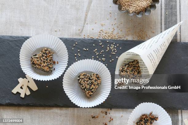 gluten-free, heart shaped sesame biscuits, baked with coconut fat and honey - cupcake holder stock pictures, royalty-free photos & images