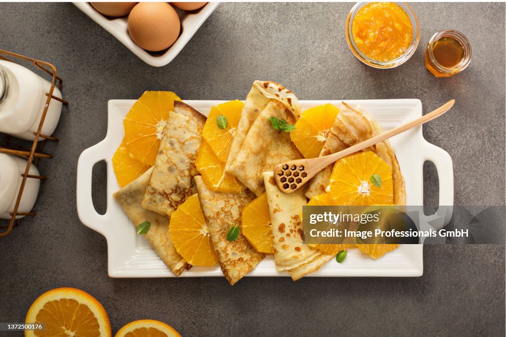 Crepes suzette with cream cheese filling, orange sauce and fresh oranges