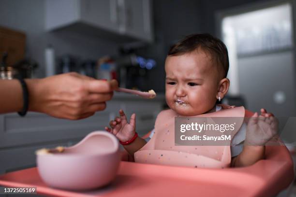 baby sitting in highchair refusing to eat - angry parent mealtime stock pictures, royalty-free photos & images