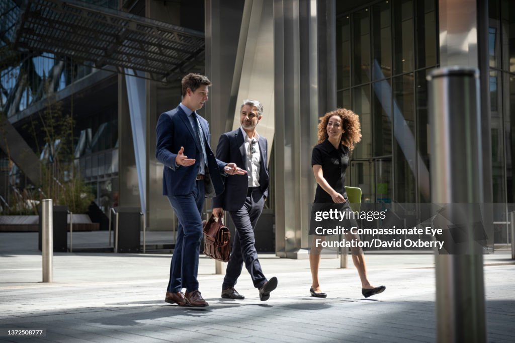 Coworkers walking and talking in the city