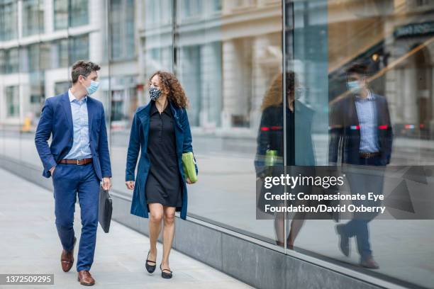 coworkers walking and talking in city - borsa per laptop foto e immagini stock