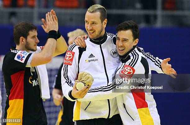 Pascal Hens and Patrick Groetzki of Germany celebrate the 24-23 victory after the Men's European Handball Championship group B match between...