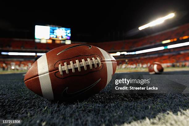 Detail of a Nike official NCAA size football as it sits in the end zone while the West Virginia Mountaineers stretchon the field prior to playing...