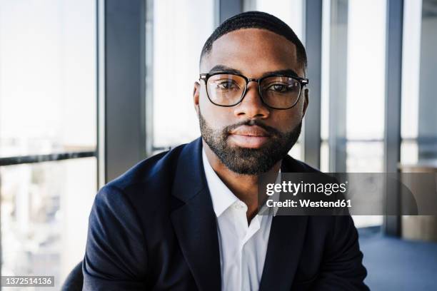 confident businessman with eyeglasses in office - 見つめる ストックフォトと画像