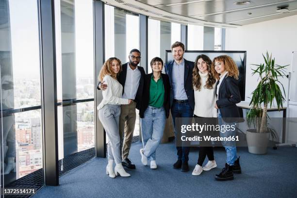 team of business colleagues standing together in office - organized group photo stock pictures, royalty-free photos & images