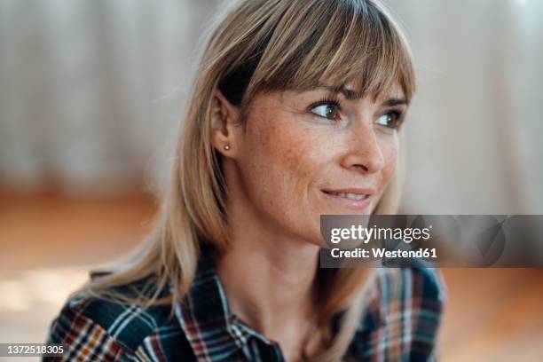 contemplative woman with bangs at home - bangs hair stock pictures, royalty-free photos & images