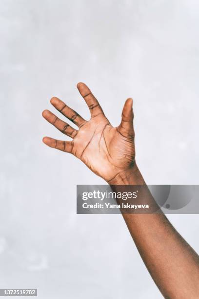 open palm of a black man - open arms stock-fotos und bilder