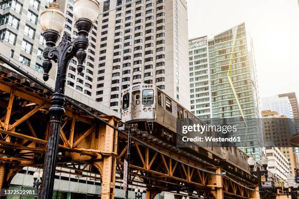 view of loop elevated train and skyscraper at, chicago, usa - loop stock-fotos und bilder