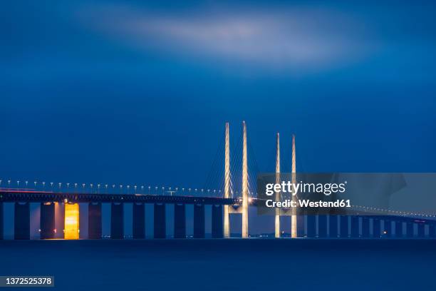 long exposure of oresund bridge at night - oresund bridge stock pictures, royalty-free photos & images
