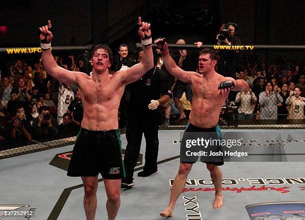 Stephan Bonnar and Forrest Griffin react after their historic three-round battle during the Light Heavyweight Final bout during the live Ultimate...