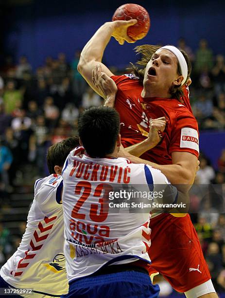 Mikkel Hansen of Denmark competes with Nenad Vuckovic of Serbia during the Men's European Handball Championship 2012 group A match between Serbia and...