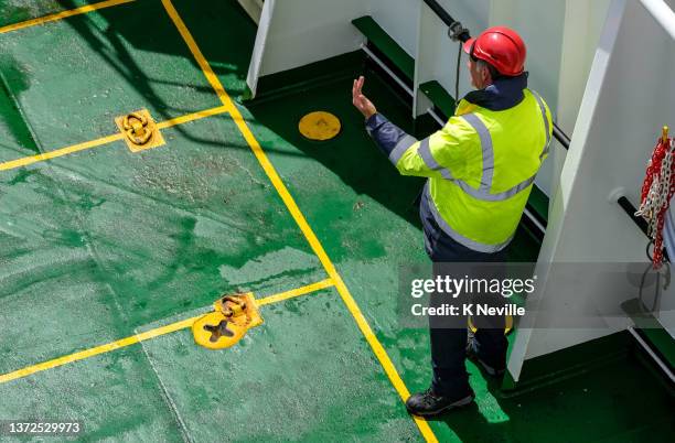 ferry crewman guiding drivers into parking bays on board - aboard stock pictures, royalty-free photos & images