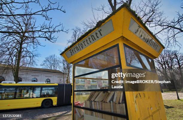 old telephone booth where books are offered for exchange, luebars, reinickendorf district, berlin, germany - telefonzelle stock-fotos und bilder
