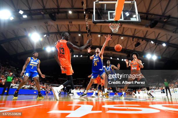 Majok Deng of the Taipans passes the ball to team mate Keanu Pinder as Tyrell Harrison of the Bullets attempts to intercept during the round 13 NBL...