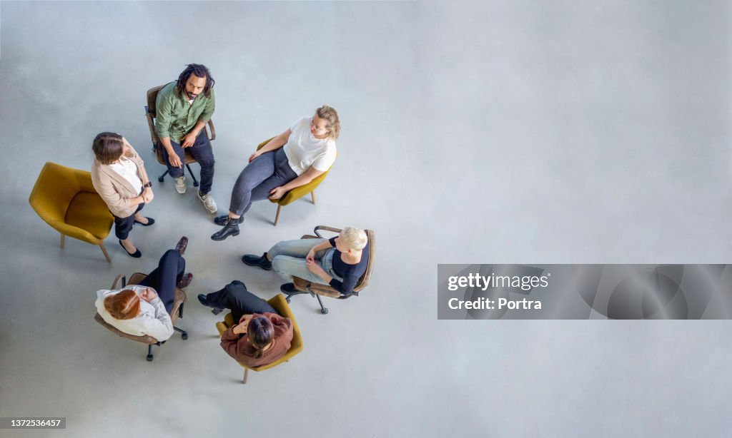 Woman sharing her experiences during a group therapy session