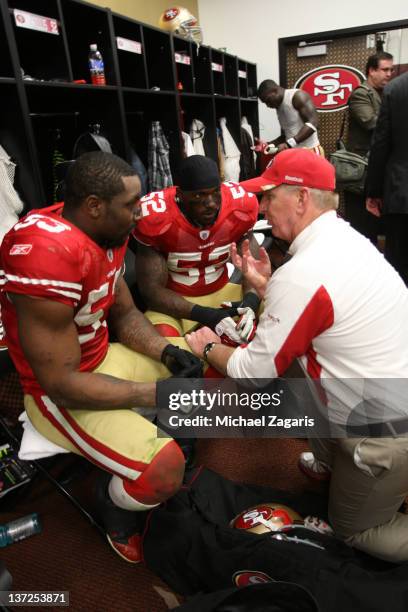Linebackers Coach Jim Leavitt of the San Francisco 49ers talks with Patrick Willis and NaVorro Bowman in the locker room following the game against...