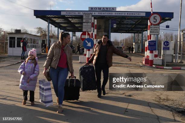 People enter Romania, after having crossed from Ukraine, on February 24, 2022 in Sighetu Marmatiei, Romania. Overnight, Russia began a large-scale...