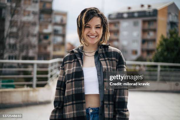 photo of beautiful teenage girl with dreadlocks smiling - crop top stock pictures, royalty-free photos & images