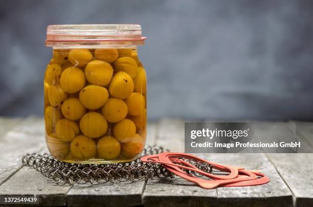 preserved small yellow plums in a glass jar - mirabelle plum stock pictures, royalty-free photos & images