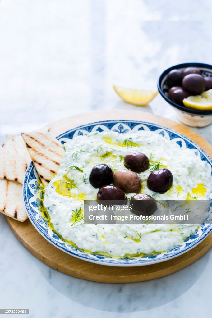 Tzatziki with olives and grilled bread