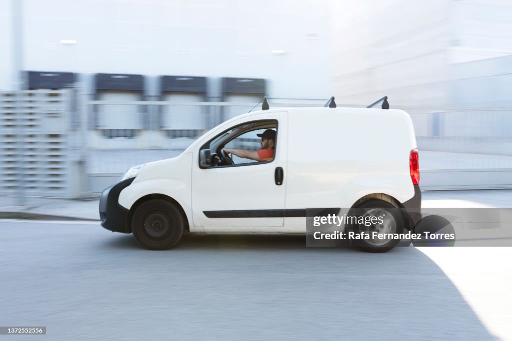 Fast delivery van travelling through the city streets