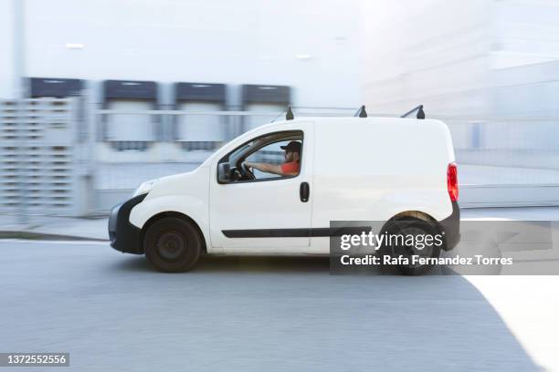 fast delivery van travelling through the city streets - van stock pictures, royalty-free photos & images