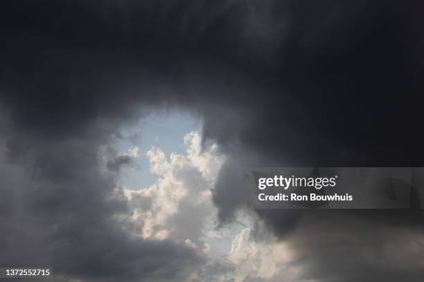 hole in the cloud - every cloud has a silver lining stock pictures, royalty-free photos & images