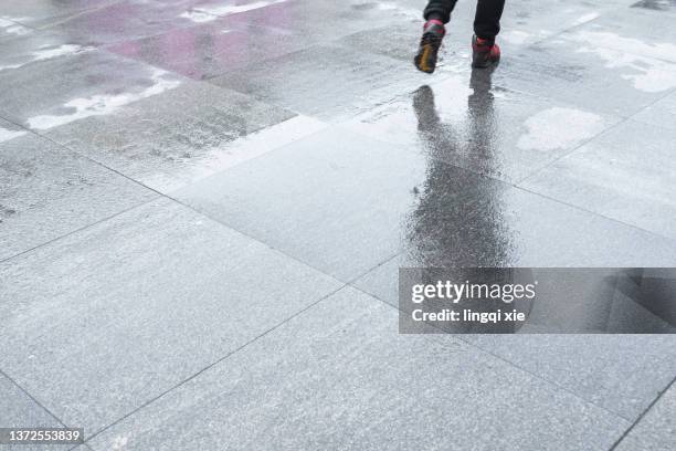 pedestrians walked on the ponding road - wet cement stock pictures, royalty-free photos & images