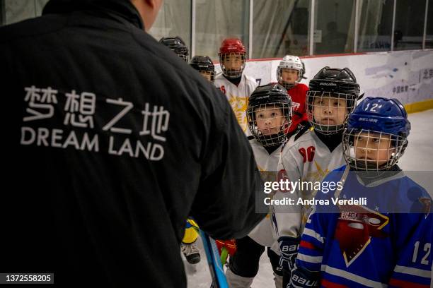Group of young boys listen to the ice hockey coach as they train on February 24, 2022 in Beijing, China. China finished the Beijing 2022 Winter...