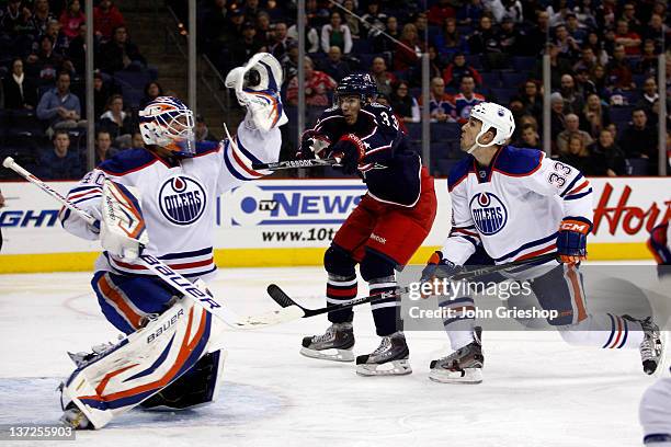 Goalie Devan Dubnyk of the Edmonton Oilers makes the save in net in front of Tomas Kubalik of the Columbus Blue Jackets during their game at...