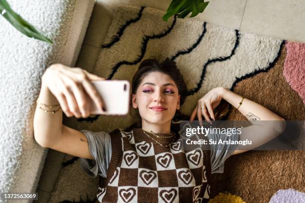 young woman taking selfie for social media - phone cover stock pictures, royalty-free photos & images