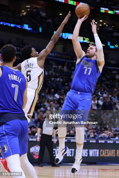 Luka Doncic of the Dallas Mavericks shoots over Herbert Jones of the New Orleans Pelicans during a game at the Smoothie King Center on February 17,...