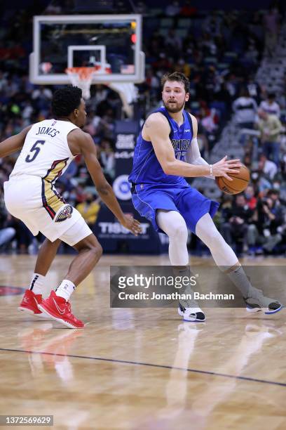 Luka Doncic of the Dallas Mavericks drives against Herbert Jones of the New Orleans Pelicans during a game at the Smoothie King Center on February...