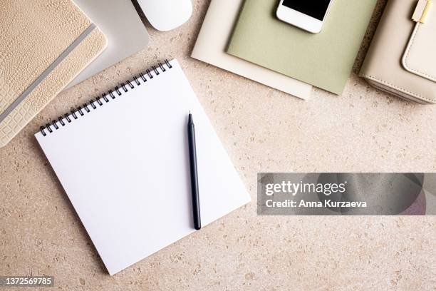 top view of office desk and stationery with blank notepad and pen from above, top view. action plan, to do list, budget plan - spiral notebook table stock pictures, royalty-free photos & images
