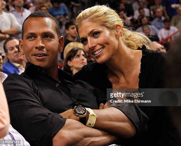 Baseball player Alex Rodriguez of the New York Yankees and Torrie Wilson watch a game between the Miami Heat and the San Antonio Spurs at American...