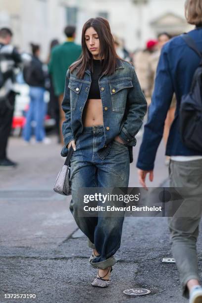 Guest wears a black cropped t-shirt, a blue and yellow denim jacket, matching blue and yellow faded baggy large pants, a black and embroidered...