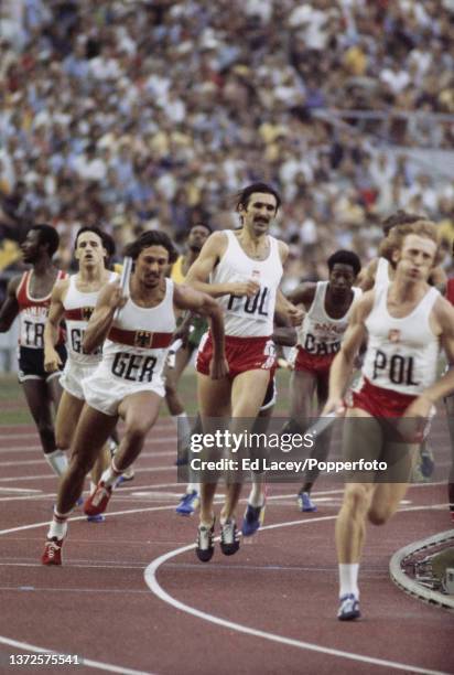 Zbigniew Jaremski of Poland takes the baton from team mate Jan Werner whilst Harald Schmid of West Germany follows in the third leg of the final of...