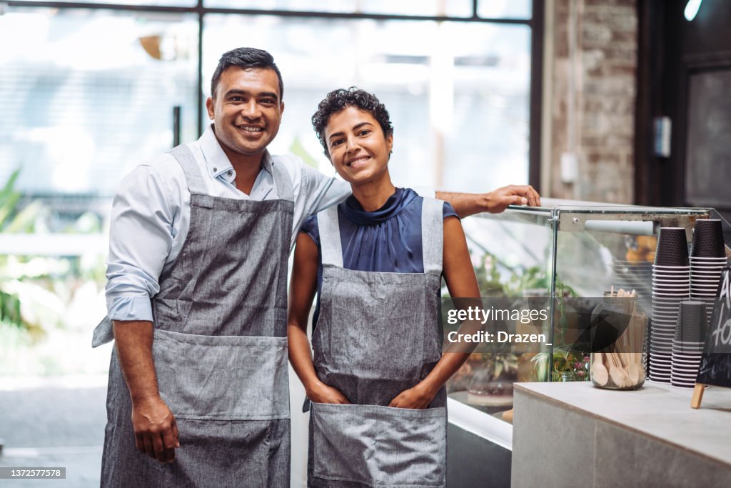 Family business - couple running restaurant and serving cutomers