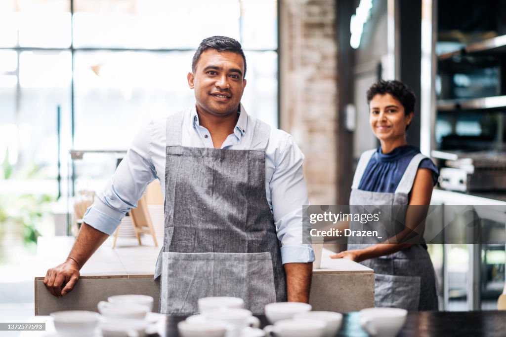 Family business - couple running restaurant and serving cutomers