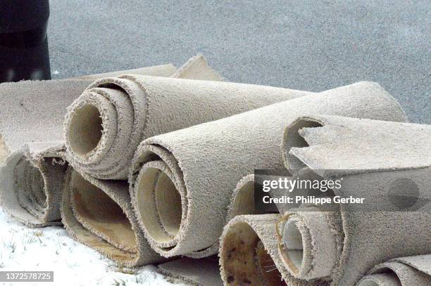 close-up of used rolled-up carpet - carpet roll stock-fotos und bilder