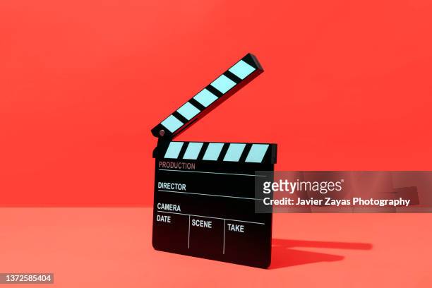clapper board on red background - weatherboard stock pictures, royalty-free photos & images