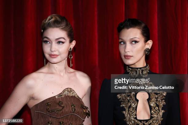Gigi Hadid and Bella Hadid pose backstage of the Moschino fashion show during the Milan Fashion Week Fall/Winter 2022/2023 on February 24, 2022 in...