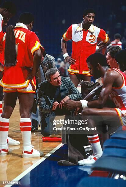 Head coach Hubie Brown of the Atlanta Hawks talks with his players while there's a timeout against the Washington Bullets during an NBA basketball...