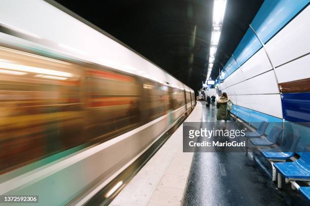 subway train in motion in a station - tunnelbanetåg bildbanksfoton och bilder