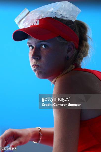 Caroline Wozniacki of Denmark cools off in her second round match against Anna Tatishvili of Georgia during day three of the 2012 Australian Open at...